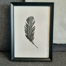 Original linoprint of a single feather. 'Feather.'