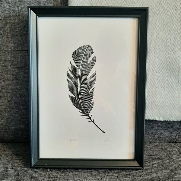 Original linoprint of a single feather. 'Feather.'