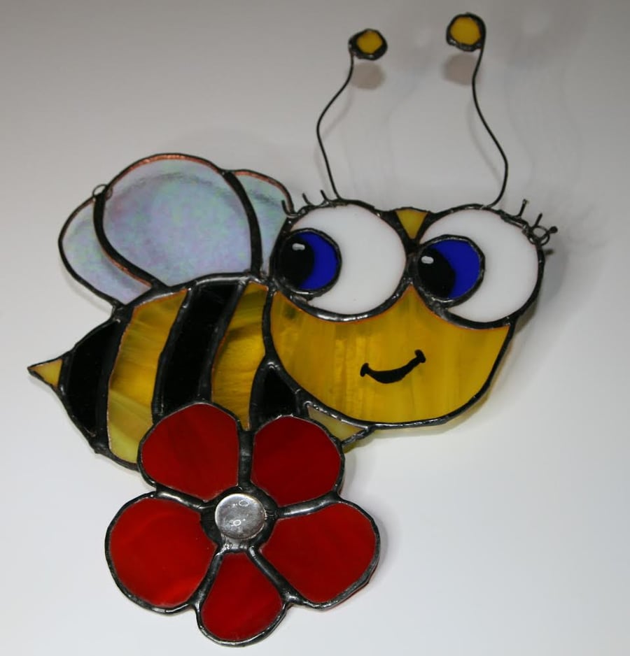 Handmade cute stained glass bee on flower