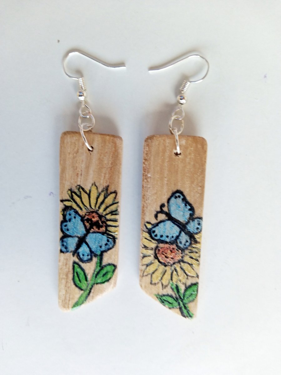 Wooden painted dangle earrings. Blue butterfly and white flowers