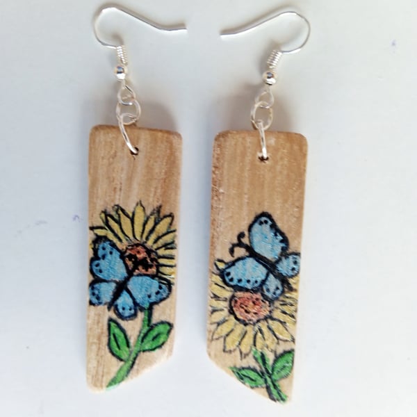 Wooden painted dangle earrings. Blue butterfly and white flowers