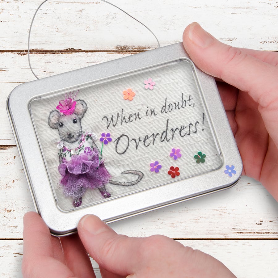 “When in doubt, overdress!” Mouse, dressed-up mouse, framed in a tin