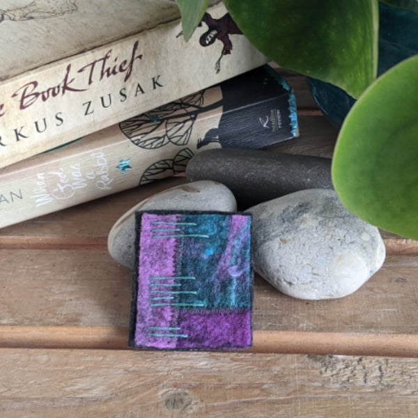 Felted patchwork brooch in shades of purple and teal