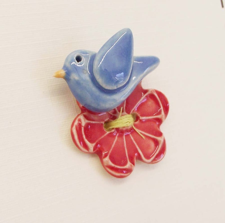 Handmade ceramic flower button with blue bird