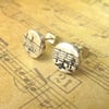 Button stud earrings with musical stave