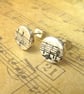 Button stud earrings with musical stave - Image 1