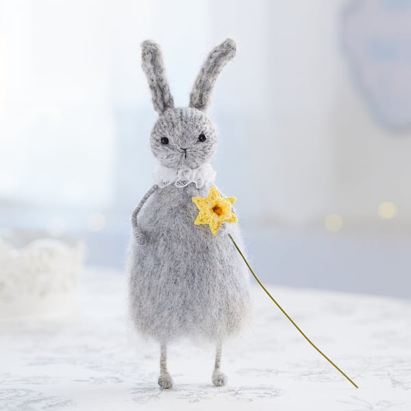 Easter bunny with a daffodil, knitted rabbit doll