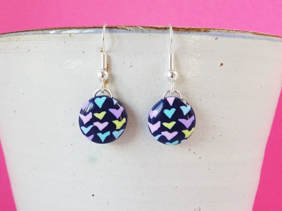 Navy circle drop earrings with pastel heart pattern