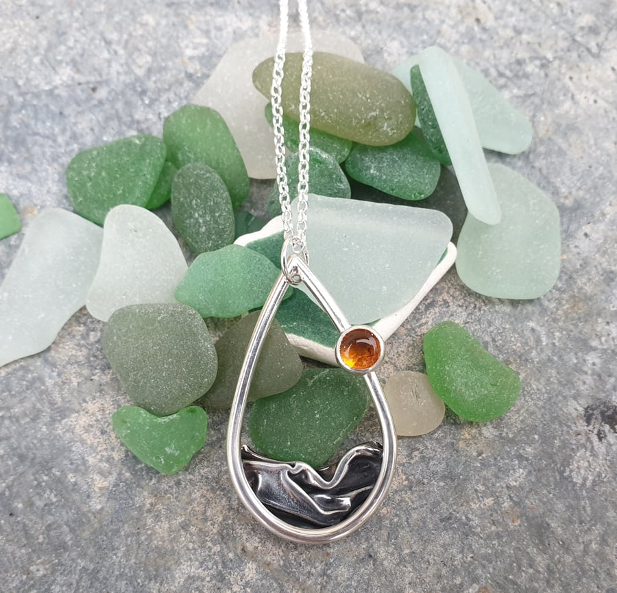 Silver and amber sun rising over sea pendant