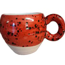 Ceramic wheel thrown Red and black Speckled Round Huggable mug .