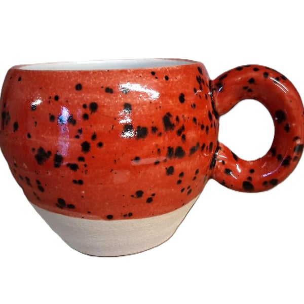 Ceramic wheel thrown Red and black Speckled Round Huggable mug .