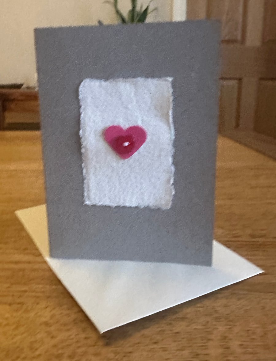 Heart motif card with red heart shaped button 