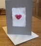 Heart motif card with red heart shaped button 
