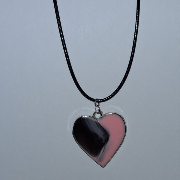 Handmade resin black and pink heart pendant on  black waxed cord