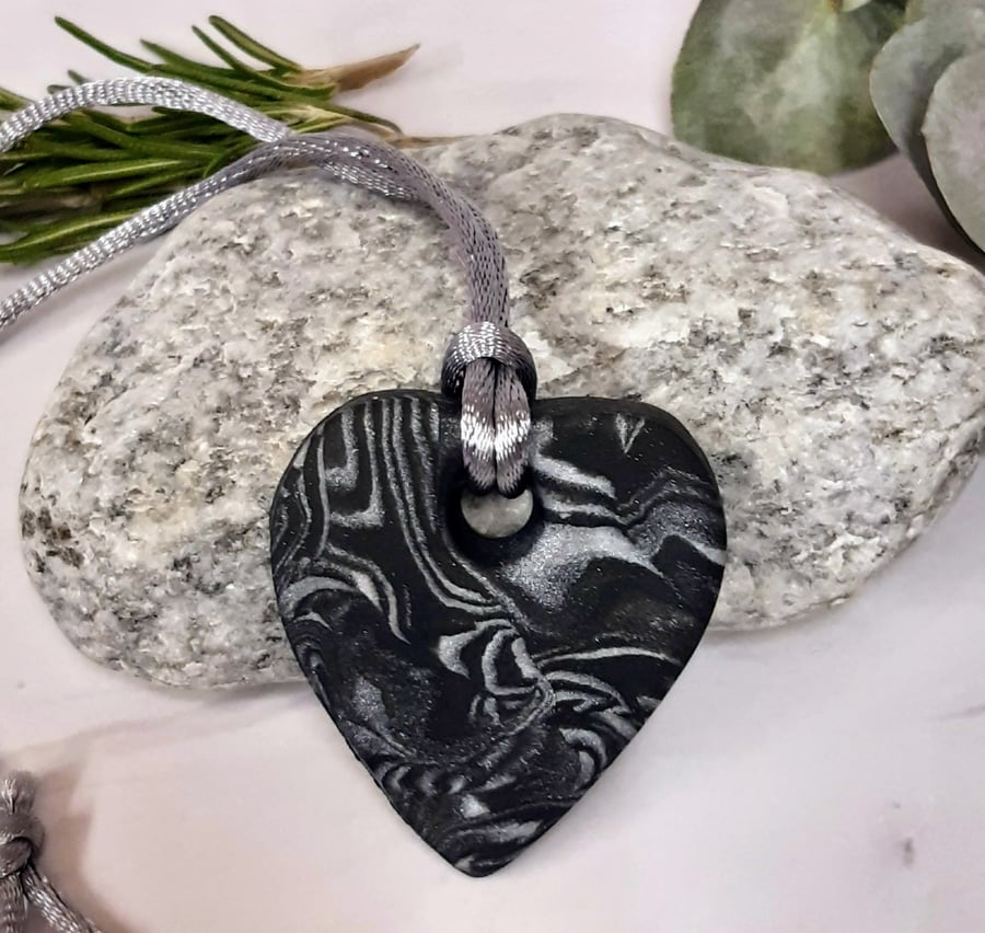 Black and silver heart shaped pendant
