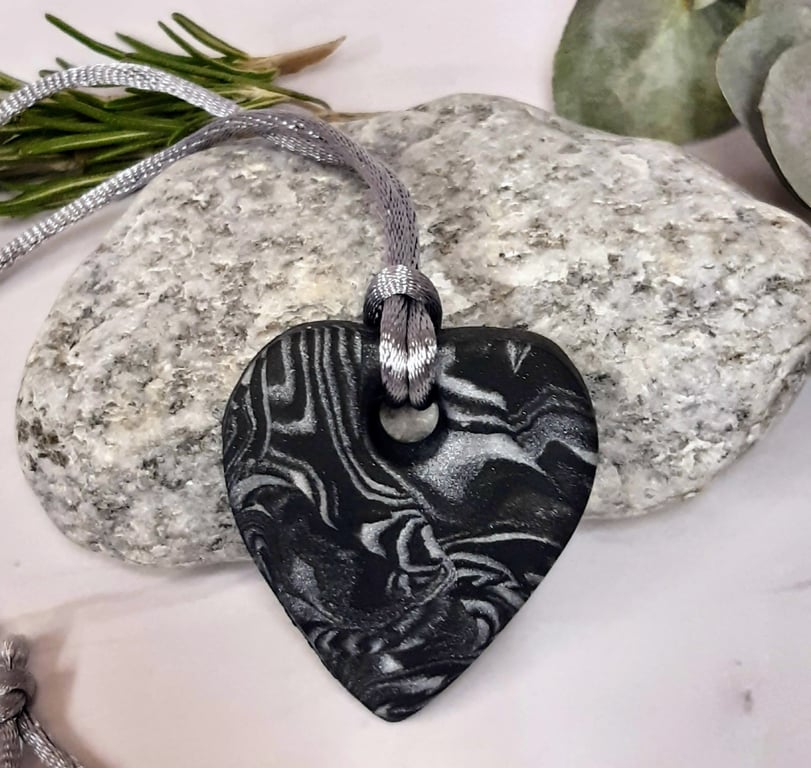 Black and silver heart shaped pendant
