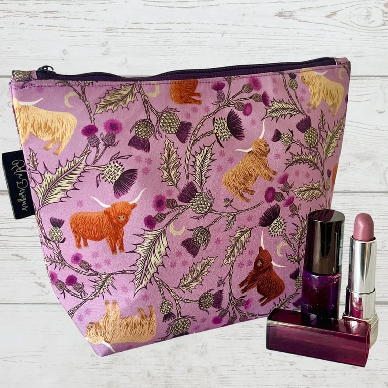 Makeup bags highland cows and silver thistles.