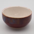 Stoneware Japanese inspired tea bowl, red with blue accents.