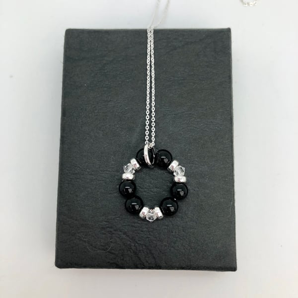 Onyx and Swarovski Crystal Circle of life pendant. Sterling Silver 