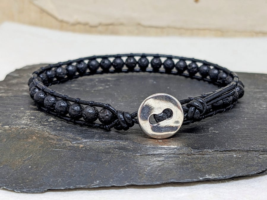 Black lava bead and leather bracelet with silver coloured button fastener 