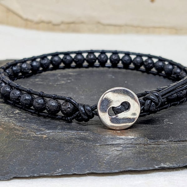 Black lava bead and leather bracelet with silver coloured button fastener 