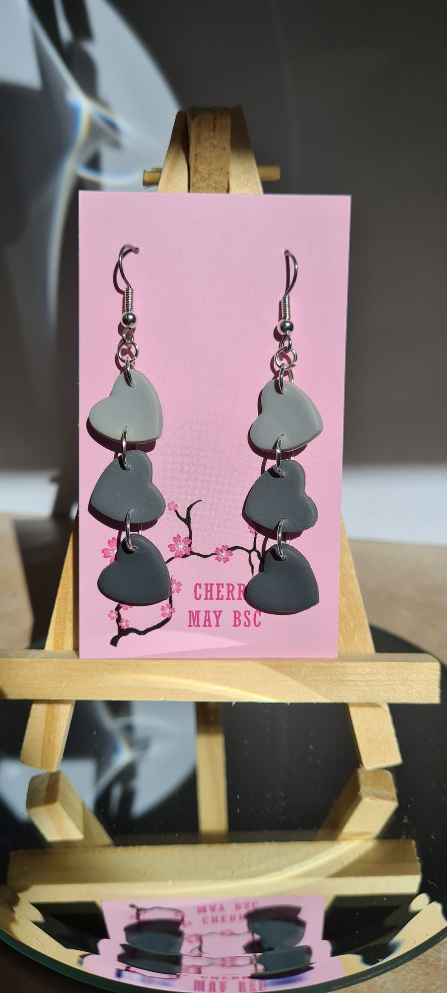 Grey hearts dangle earrings