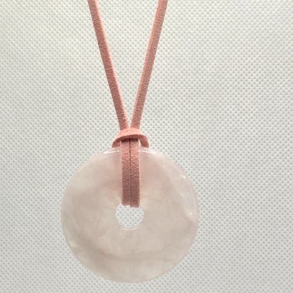 Large rose quartz donut pendant with pink faux leather cord