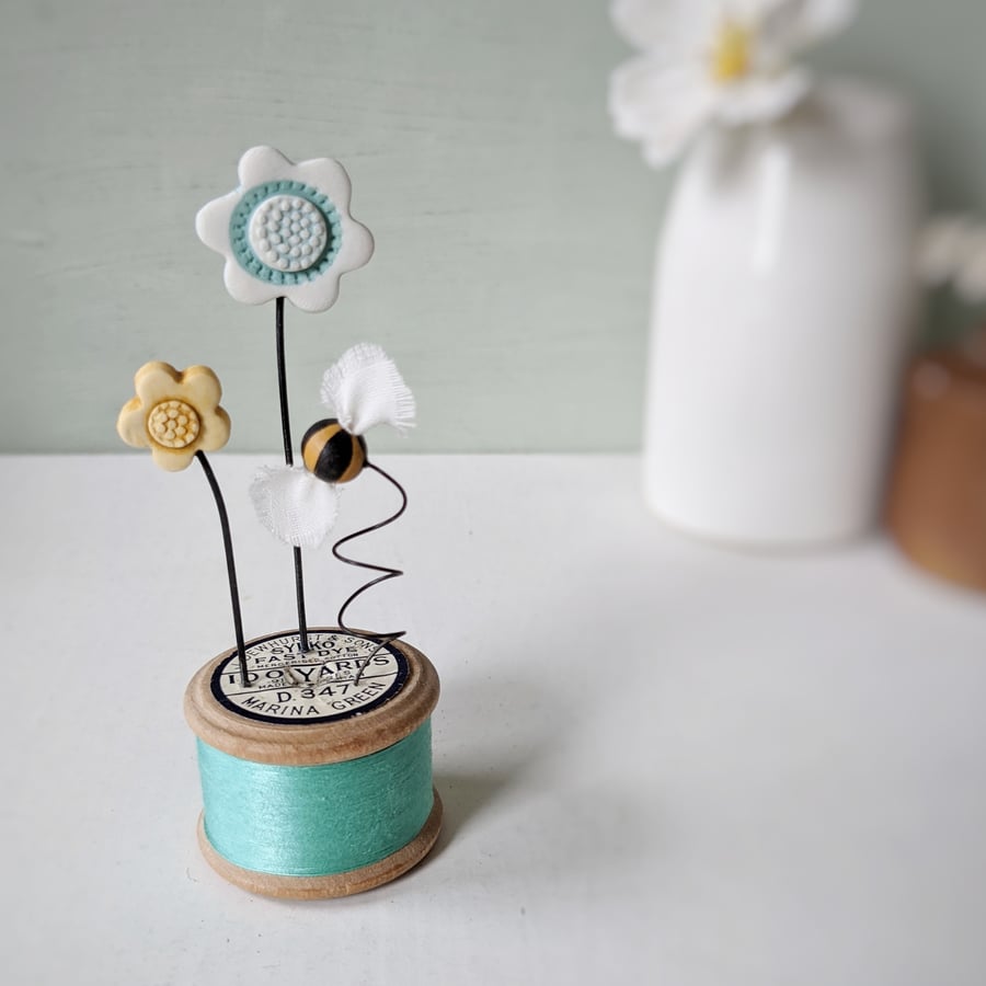 Clay Flowers and Bee on a Vintage Bobbin