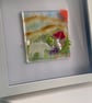 Handmade fused glass panel in a white frame