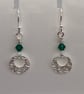 Circular, pure silver earrings with swirly, pattern and green Swarovski crystals