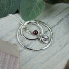 Circles Necklace. Recycled Sterling Silver Pebble with Carnation and Garnet