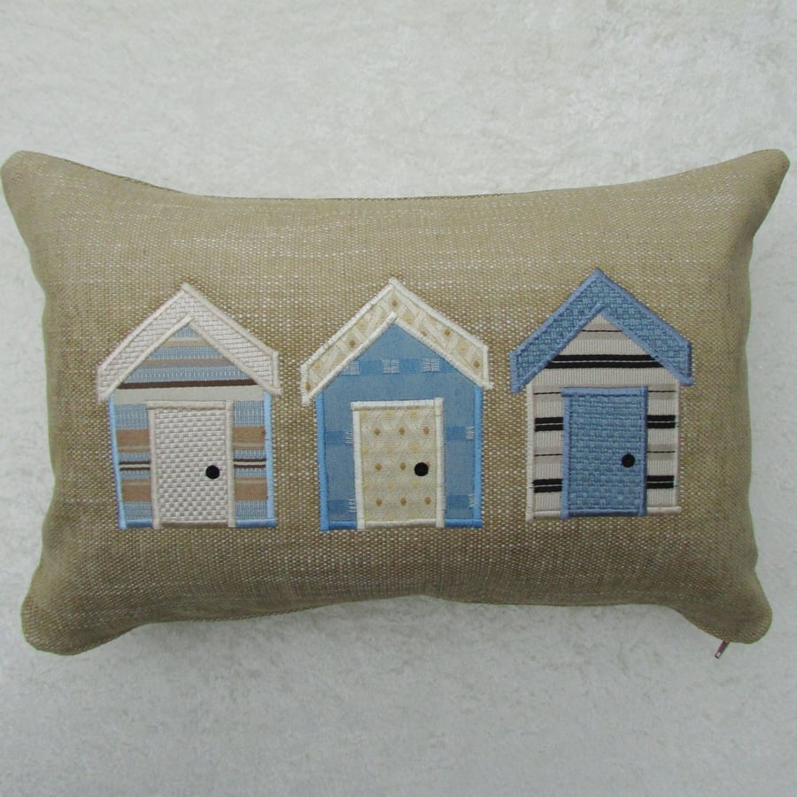 Rectangular beach huts cushion in sandy beige with blue and cream huts