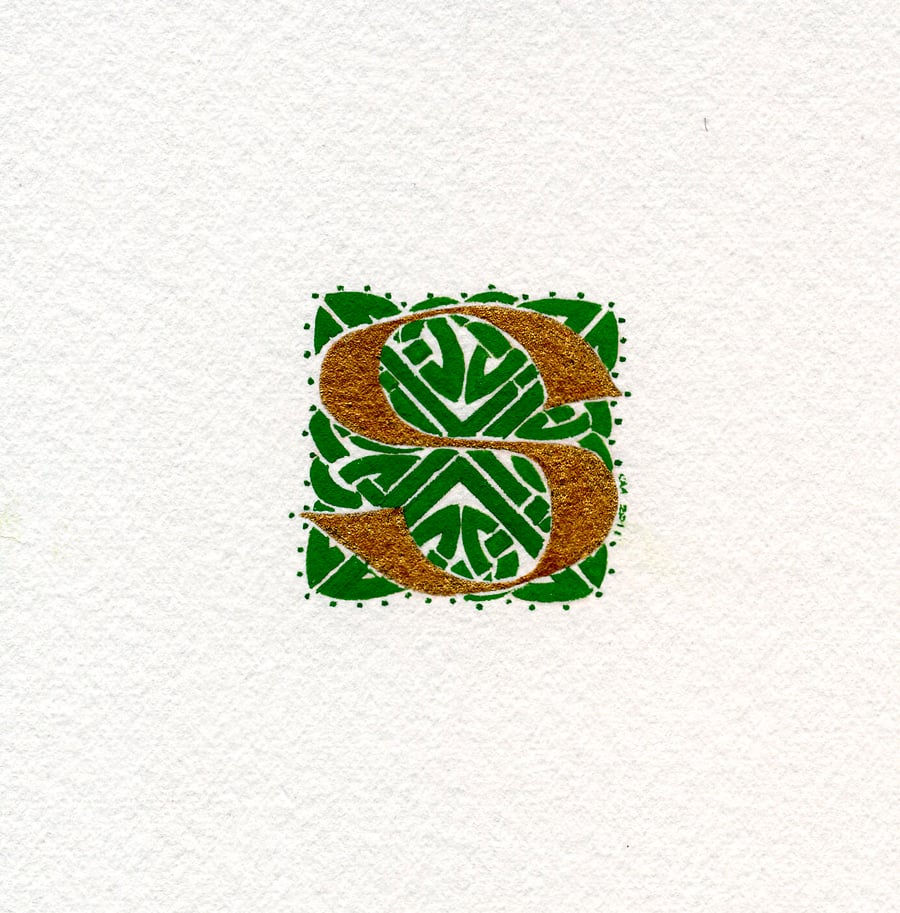 Letter S in gold with green Celtic knotwork panel.