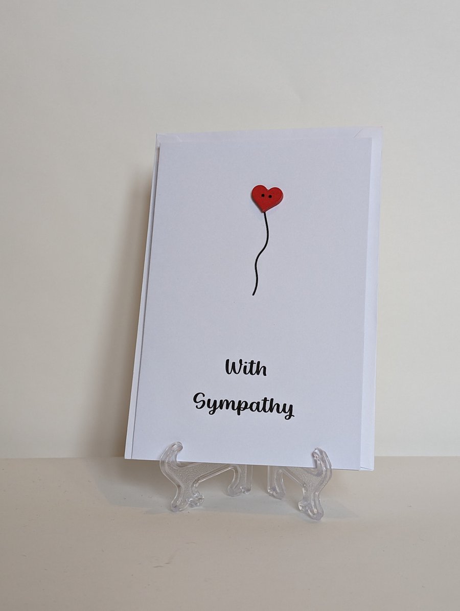With Sympathy card with a red heart button