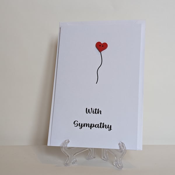 With Sympathy card with a red heart button