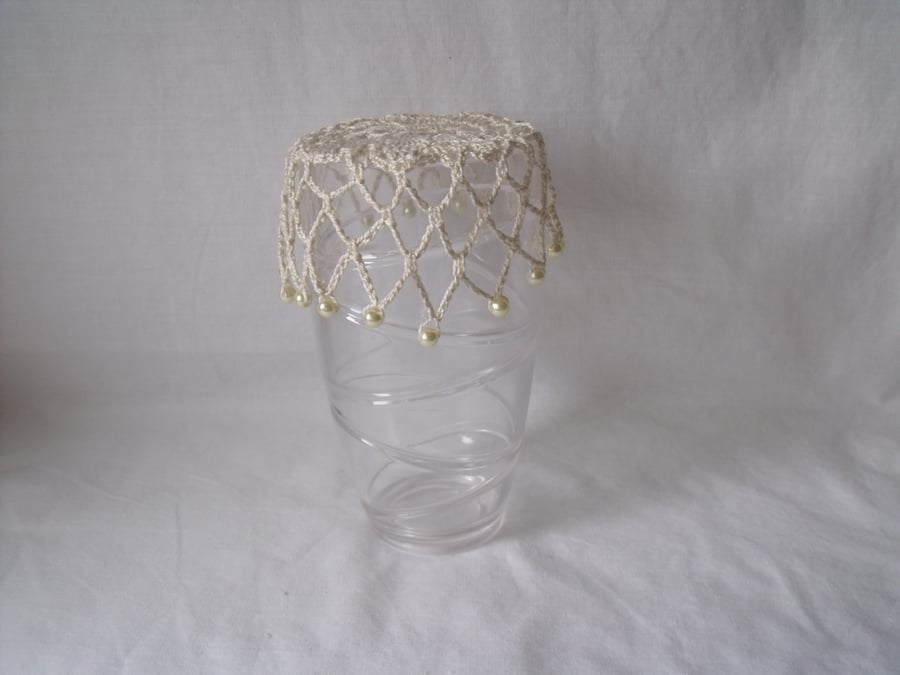 vintage style crocheted beaded doily jug cover to repel bugs when outdoors 
