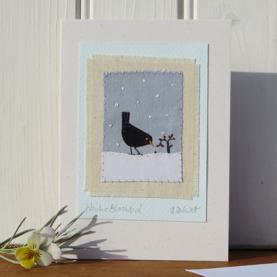 Winter Blackbird hand-stitched miniature on card with berries and falling snow