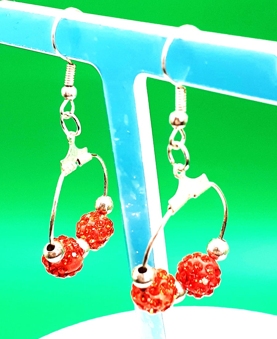 Elegant Silver Hoop Earrings with Sparkling Red Rhinestone Beads.