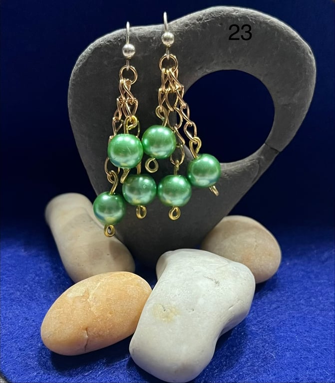 Beautiful dangling earrings on gold coloured chain with green beads.