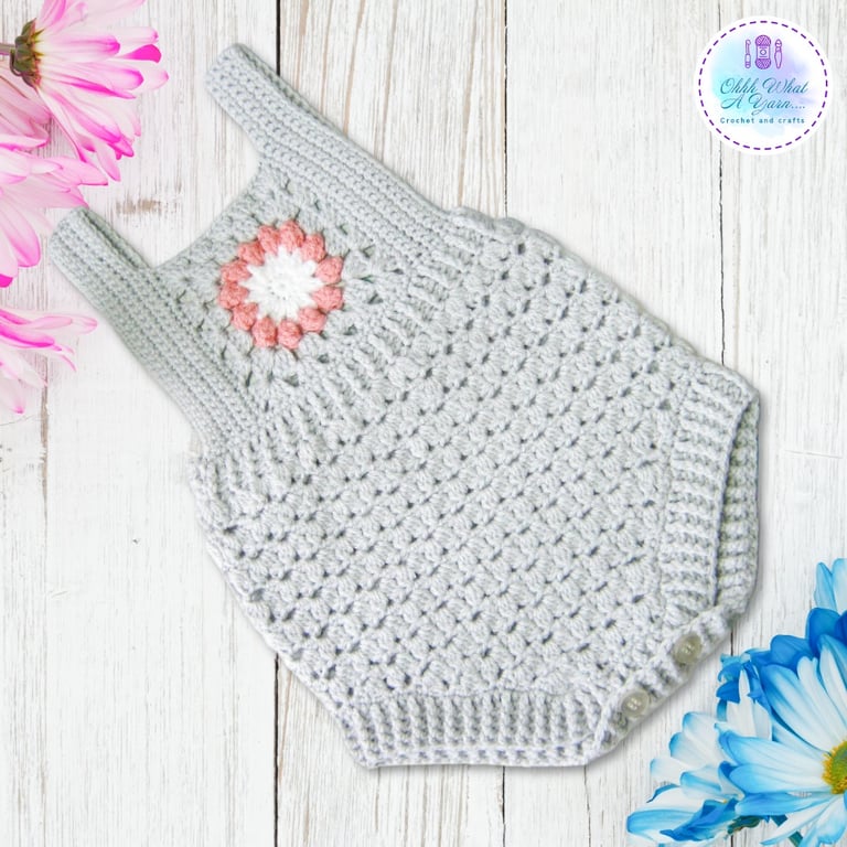 Grey and pink crochet baby romper with flower detail.  Age 6-9 months