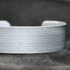 Geometric waves pattern cuff bracelet grey