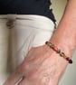 Slender glass bead bracelet in earthy shades of red and orange.  - Image 3