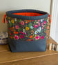 Drawstring project bag made with bright floral print in grey and orange - Image 1