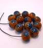 Handmade teal and mustard daisy patterned lamp work glass beads - Image 10