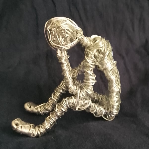 Thinking man made of wire 