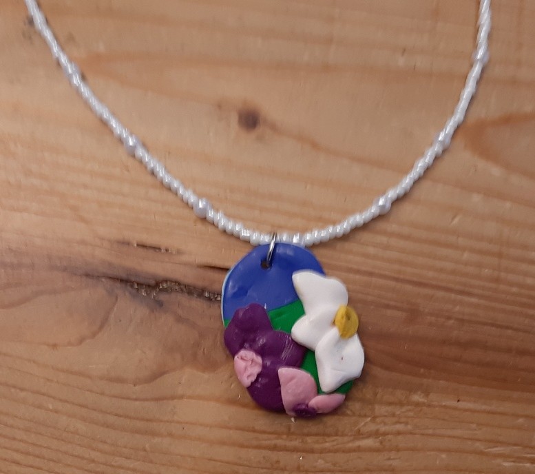 Flower Pendant on a White Beaded Necklace