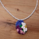Flower Pendant on a White Beaded Necklace