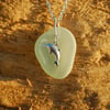 Sea glass pendant with sterling silver dolphin
