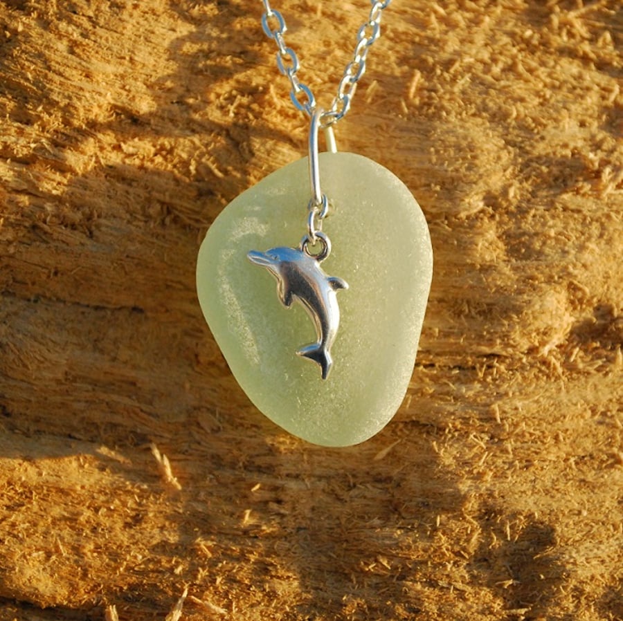 Sea glass pendant with sterling silver dolphin