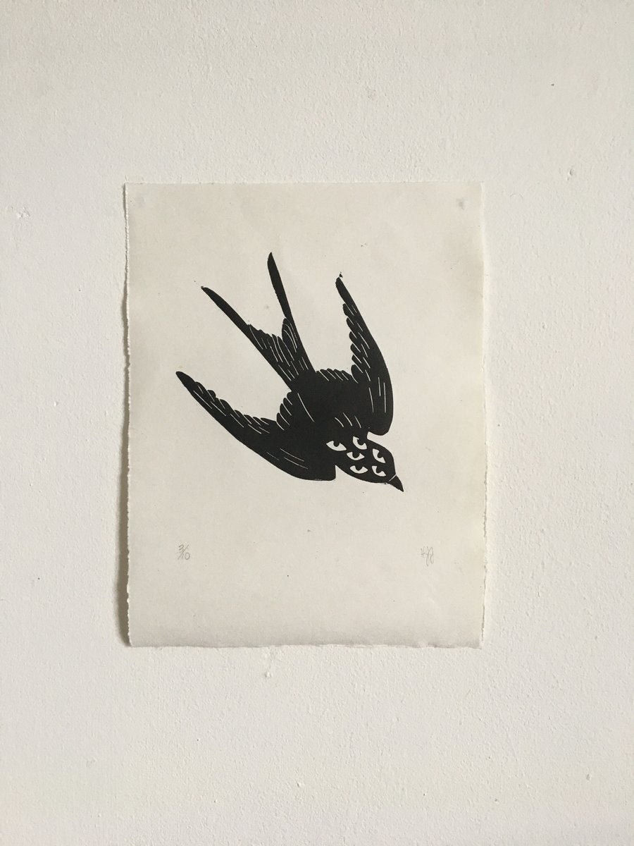 Migration, linocut print of a swallow